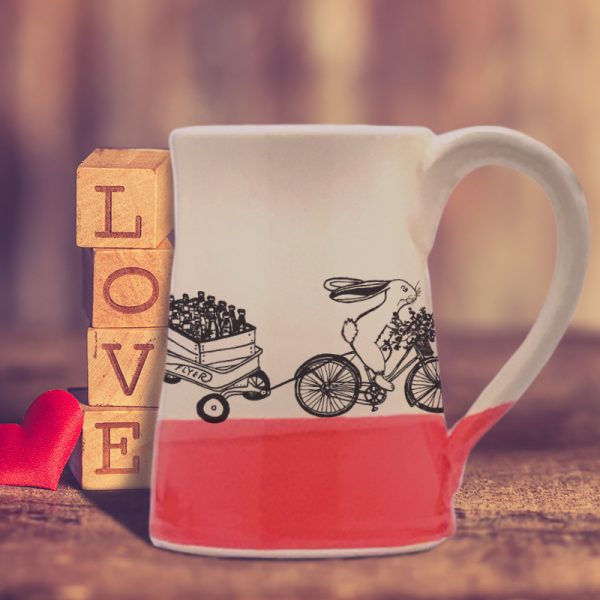 Large coffee mug handmade by hedgehogs with an illustration of yet another Ale on Wheels delivery person. This rabbit is new and not particularly fast. Red accent color
