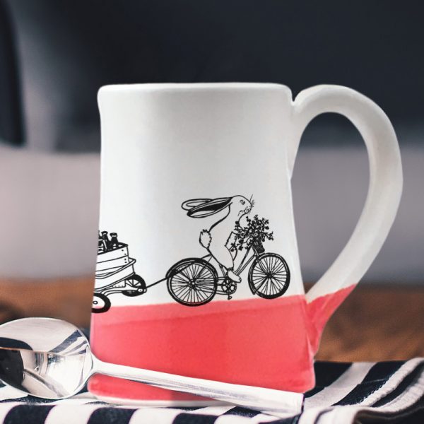 Large coffee mug handmade by hedgehogs with an illustration of yet another Ale on Wheels delivery person. This rabbit is new and not particularly fast. Red accent color