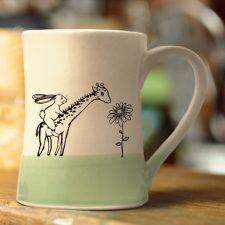 Large mug, handmade and illustrated by Darn Pottery hedgehogs, appears to have a rabbit riding a giraffe. Surely, this can't be happening. Green accent color