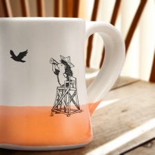 The most important moment in all of American history is portrayed on this handmade mug: vigilant hedgehog at the beach looking for the British armada. Coral accent color.