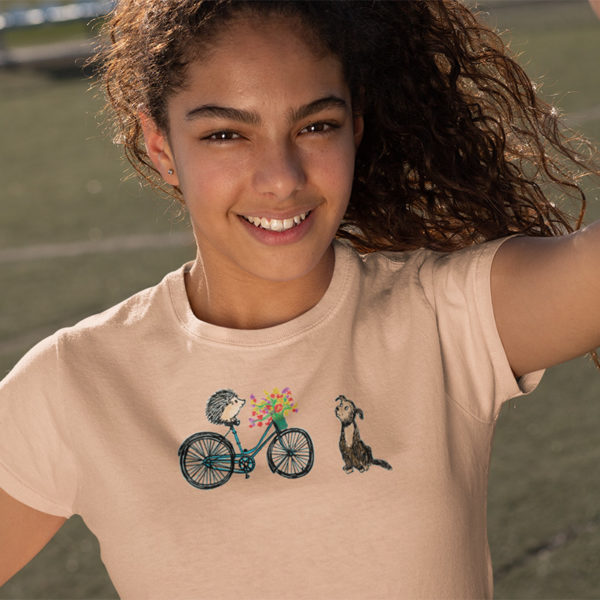 Woman wearing graphic T-shirt with original drawing of a hedgehog on a bike delivering flowers to a dog