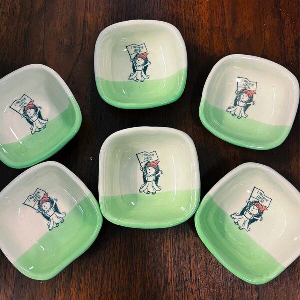 6 small handmade dishes with a drawing of a hedgehog holding a sign that says I believe her
