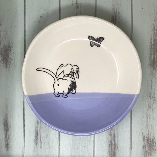 handmade ceramic salad plate with drawing of a cute dashchund chasing a butterfly