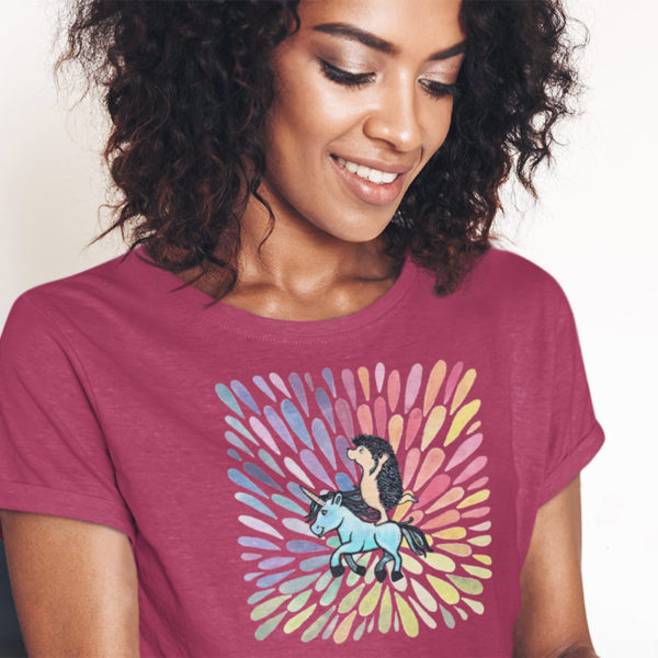 Woman wearing graphic T-shirt with original drawing of a hedgehog riding a unicorn
