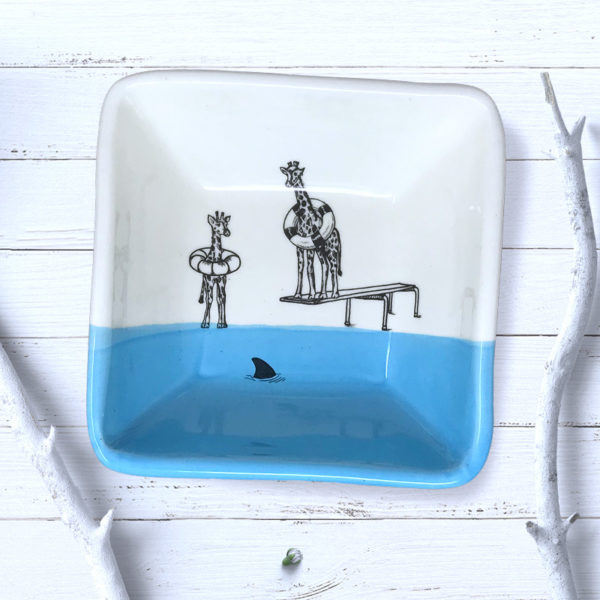 square blue bowl with drawing of giraffes in life preservers