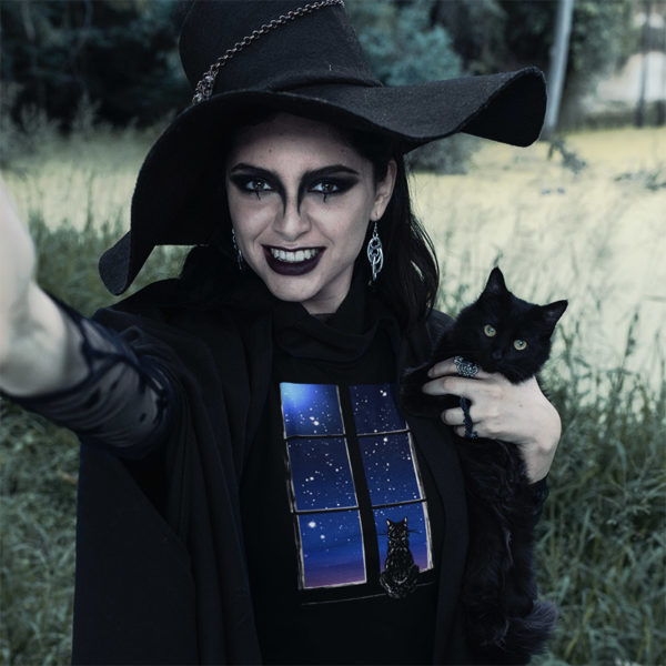 Photograph of witchy woman wearing original graphic tshirt with cat
