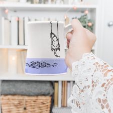 Coffee Mug created and illustrated by Darn Pottery hedgehogs depicts a tender moment between a feline and her breakfast. Lavender accent color. For the cat lovers.