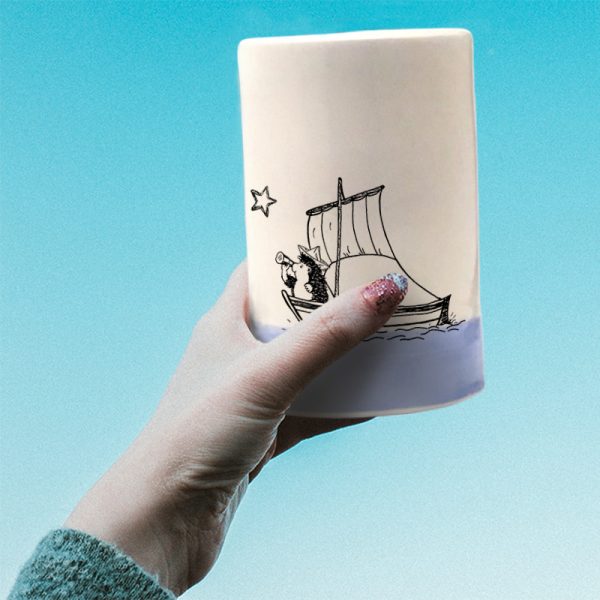 A handmade tumbler with a drawing of a hedgehog on a sailboat, probably plotting a daring exploit. Lavender accent color.