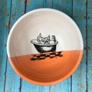 handmade soup bowl with drawing of a cat in a bathtub. Coral accent color