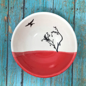 small bowl with drawing of birds. red accent color