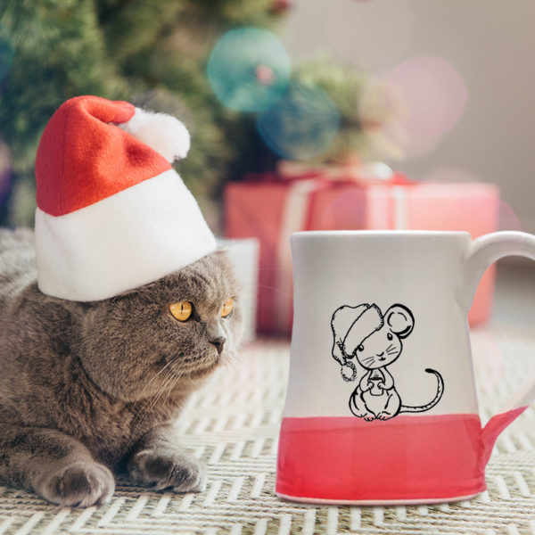 Handmade coffee mug with illustration of a little mouse in a Santa hat. Red accent color