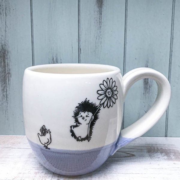 cocoa mug with hedgehog flying in on a flower