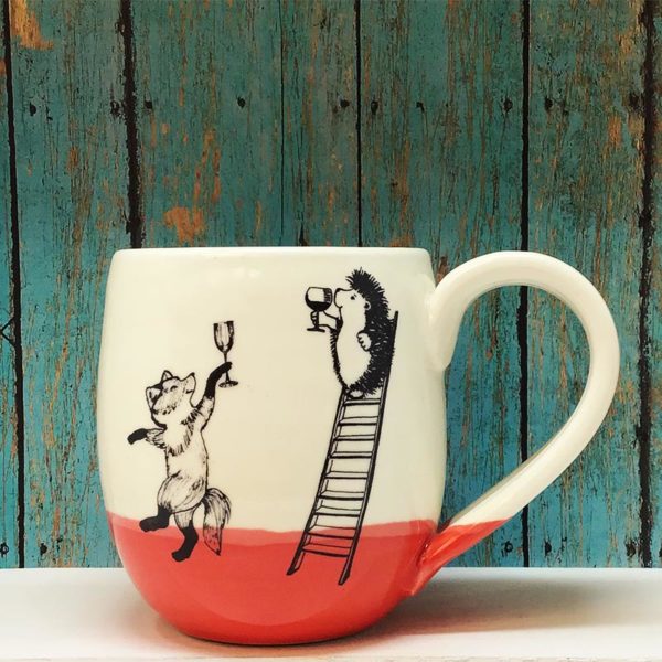 Handmade ceramic cocoa mug with drawing of hedgehog and fox celebrating