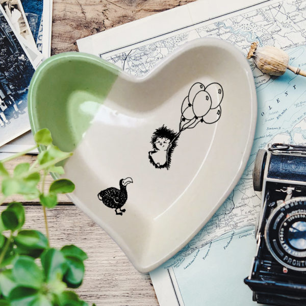 Handmade ceramic heart-shaped dish with drawing of hedgehog and dodo. Green accent color