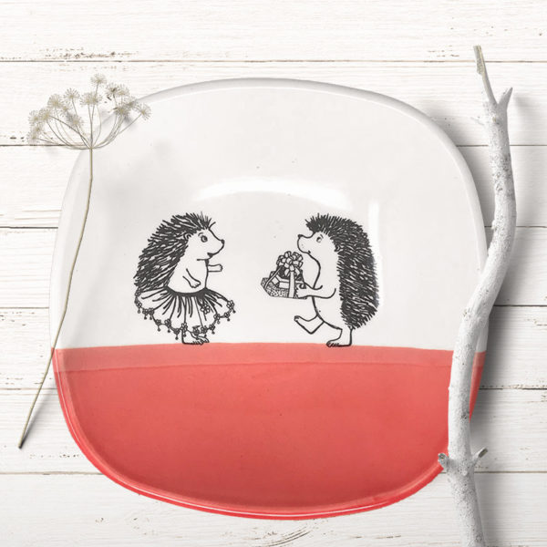 square salad plate with drawing of hedgehog carrying gifts to a lady hedgehog