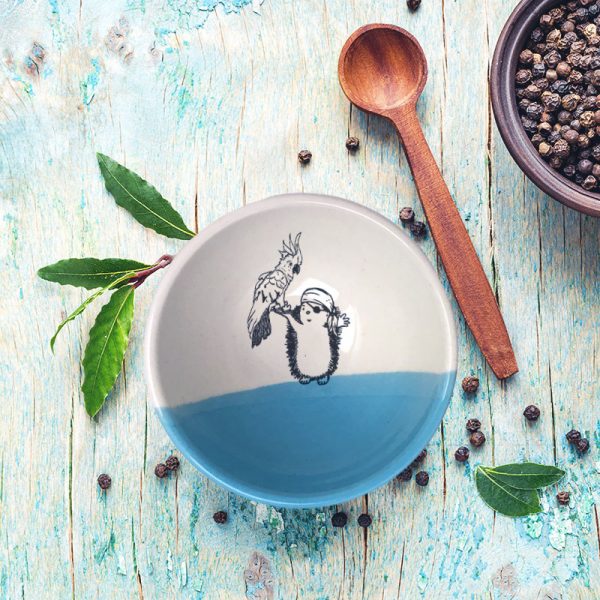 No pirate is complete without a sidekick. The parrot and the hedgehog pirate are a great team and are featured in the drawing on this handmade ceramic bowl. Blue accent color.