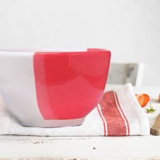 Side view of Darn Pottery Soup Bowl. Red accent color.