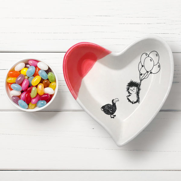 Handmade ceramic heart-shaped dish with drawing of hedgehog and dodo. Red accent color