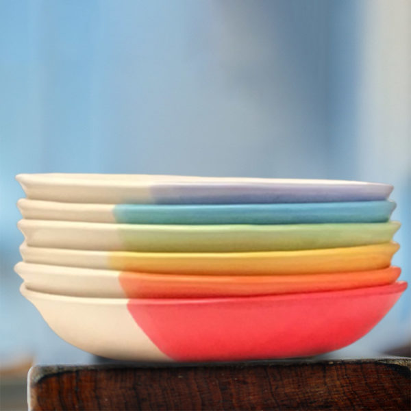 Stack of colorful salad plates made by Darn Pottery