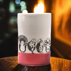 A handmade tumbler with an action drawing of the Village Hedgehogs, a late 70's singing phenomenon. A musical tour de force, they eclipsed both ABBA and the Jackson 5. Red accent color.