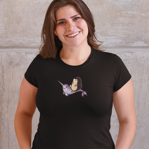 Woman wearing a graphic T-shirt with original drawing of a hedgehog riding a narwhal