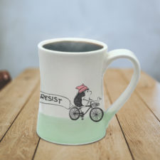 Handmade mug with resistance hedgehog on bike. Vote. Dissent. Resist. Green accent..