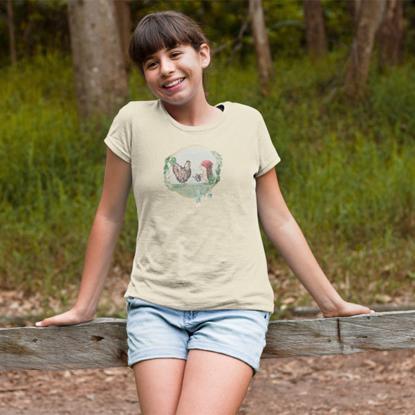 Girl wearing graphic T-shirt with original drawing of a rooster and hedgehog in the garden