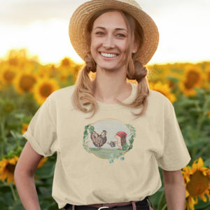 Girl wearing graphic T-shirt with original drawing of a rooster and hedgehog in the garden