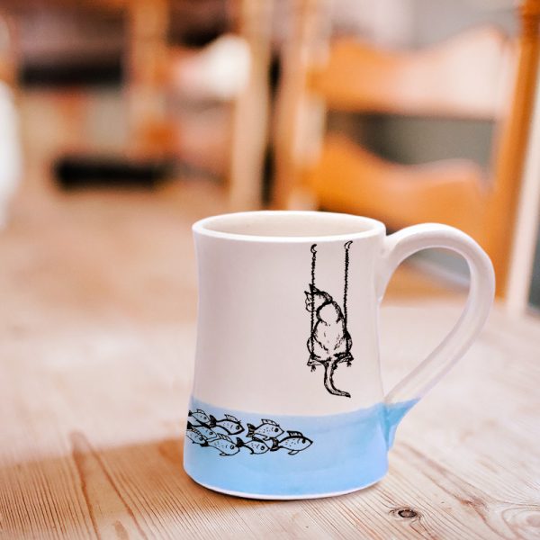 Coffee Mug created and illustrated by Darn Pottery hedgehogs depicts a tender moment between a feline and her breakfast. Blue accent color. For the cat lovers.