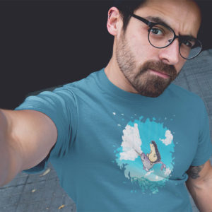 Man wearing a graphic T-shirt with original drawing of a hedgehog flying over the ocean on the back of a narwhal