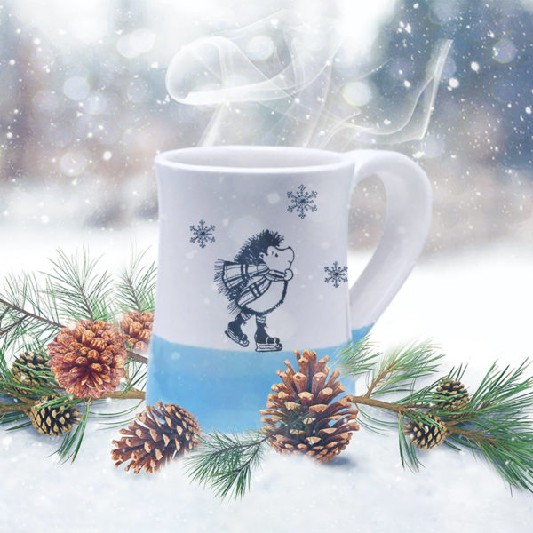 Handmade coffee mug with a drawing of a hedgehog ice skating and looking dapper. Blue accent color.