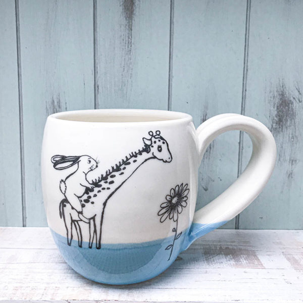 cocoa mug with rabbit riding a giraffe