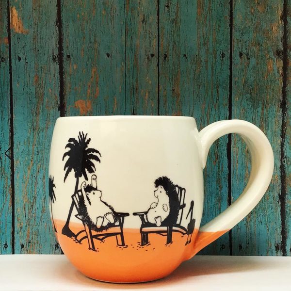 Handmade ceramic cocoa mug with drawing of hedgehogs on a beach