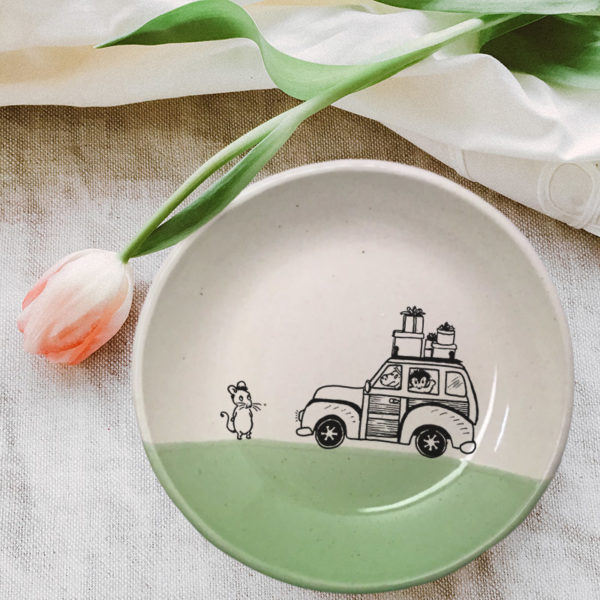 Handmade salad plate with crawing of a mouse and a car loaded with presents. Green accent color