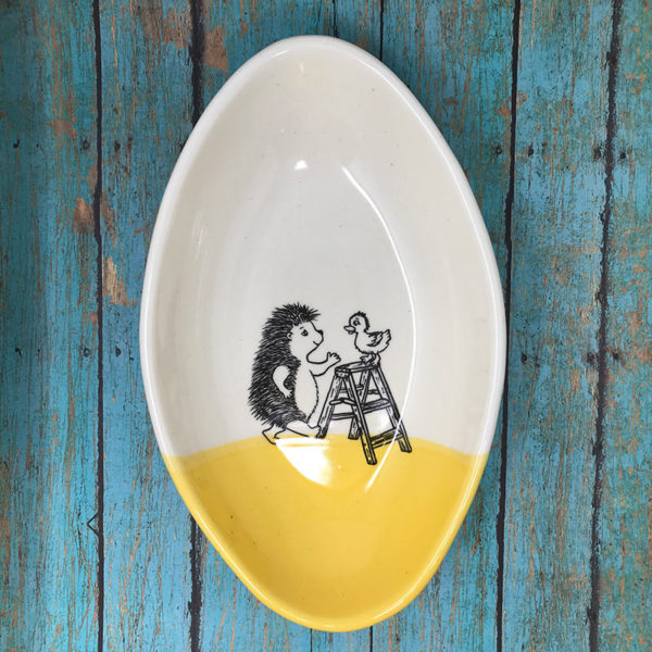 Handmade dish with drawing of hedgehog talking to a duck