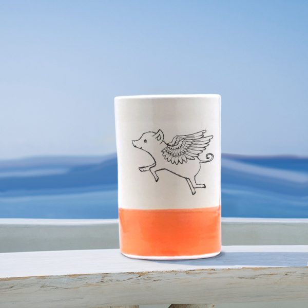A lovely ceramic tumbler handmade by hedgehogs and illustrated with a really cute flying pig. Coral accent color.