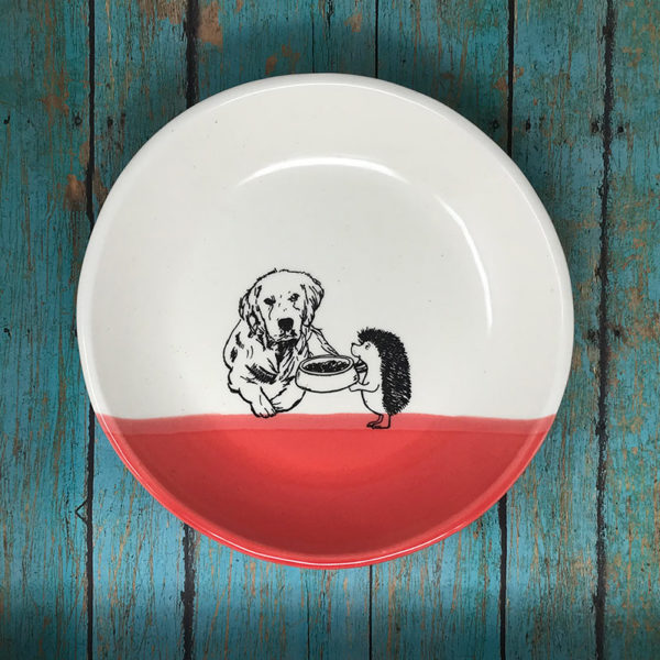 handmade ceramic plate with drawing of a dog and hedgehog. red accent color