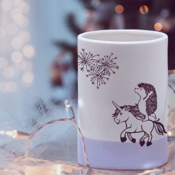 A handmade ceramic tumbler with a drawing of the cutest damned hedgehog doing pirouettes on a unicorn. Rediculous. Lavender accent color.