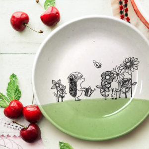 Handmade ceramic salad plate with drawing of a hedgehog and rabbit in a garden. Green accent color