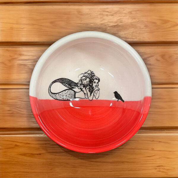 handmade ceramic bowl with drawing of a mermaid talking with a crow