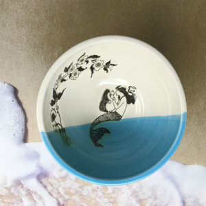 handmade ceramic bowl with drawing of a mermaid kissing a hedgehog