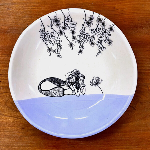 Handmade ceramic plate with drawing of a mermaid and garlands of flowers. Lavender accent color