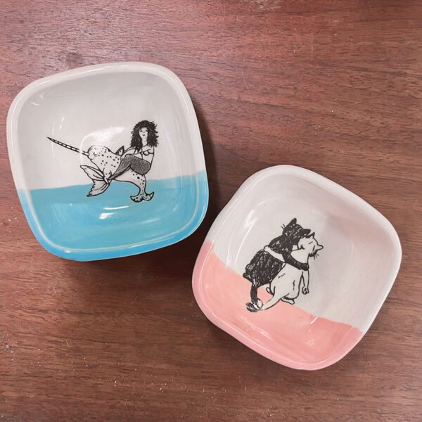 two tiny handmade dishes one with mermaid and another with kittens