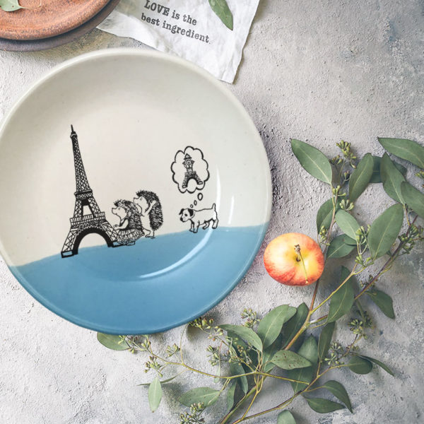 Handmade ceramic plate with drawing of hedgehogs visiting the Eiffel Tower, and their dog dreaming of peeing on it. Blue accent color