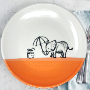 Dinner plate with drawing of elephant holding an umbrella over a little owl