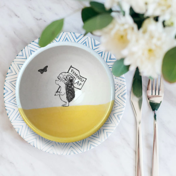 Handmade ceramic soup bowl with a drawing of a hedgehog holding a Feminist AF sign. Gold accent color.