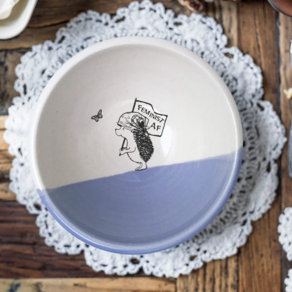 Handmade ceramic soup bowl with a drawing of a hedgehog holding a Feminist AF sign. Lavender accent color.