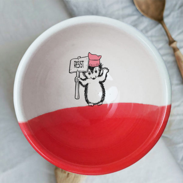 Handmade ceramic soup bowl with a drawing of a hedgehog holding a Resist protest sign. Red accent color.