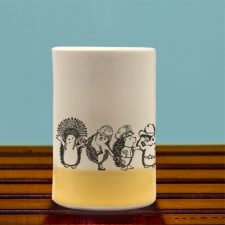 A handmade tumbler with an action drawing of the Village Hedgehogs, a late 70's singing phenomenon. A musical tour de force, they eclipsed both ABBA and the Jackson 5. Gold accent color.